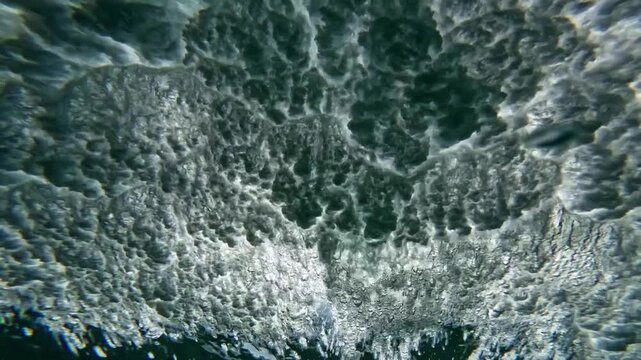 Ocean wave. Underwater view of clear ocean wave breaking over corral reef. spinning vortex, clouds. powerful nature, strong wave, danger of drowning. slow motion.