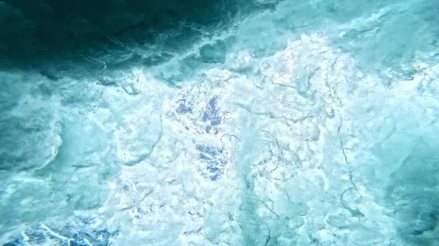 Ocean wave. Underwater view of clear ocean wave breaking over corral reef. spinning vortex, clouds. powerful nature, strong wave, danger of drowning. slow motion.