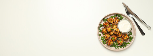 Stuffed mushrooms, sauce and cutlery on white background, space for text