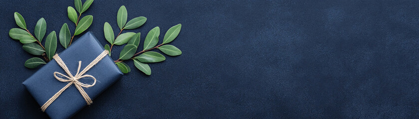 A blue box with a green ribbon on top of a blue background