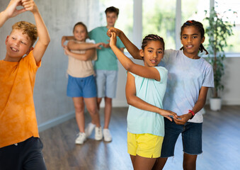 African boy and girlie learn figures of pair dance and train before competition. Children fitness...