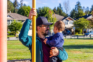 Obraz premium Father and Child Enjoy a Sunny Day at the Park in Mission, BC, Canada