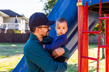Obraz premium Father and Child Enjoying a Sunny Day at the Playground in Mission, BC, Canada