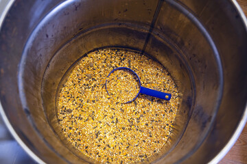 An almost empty barrel of feed grain mixture for chickens