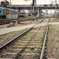 Obraz premium View of train Railway Tracks from the middle during daytime at Amritsar railway station in India, Train railway track view, Indian Railway junction, Heavy industry