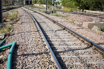 Naklejka premium View of train Railway Tracks from the middle during daytime at Amritsar railway station in India, Train railway track view, Indian Railway junction, Heavy industry