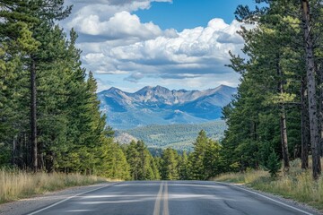 Fototapeta premium Road with a distant view of mountains, pine trees framing the scene, majestic and vast