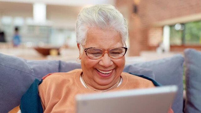 Laughing, tablet and senior woman on sofa for streaming, news website or social media memory in nursing home. Smile, meme and old person on couch on digital app for happy scroll, fun search and relax