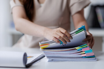 Adult businesswoman or auditor examining documents and laptop. financial document reports,...