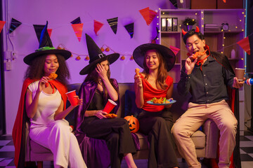 Obraz premium An African American woman and a white woman celebrate with coworkers, drinking, having fun, and smiling together at a lively Halloween night party filled with joy and laughter.