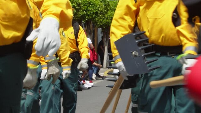 group of fireman wearing special antifire, flame resistant jacket, gloves, pants and shoes. Fireman marching in a parade. Antifire, flame resistance equipment