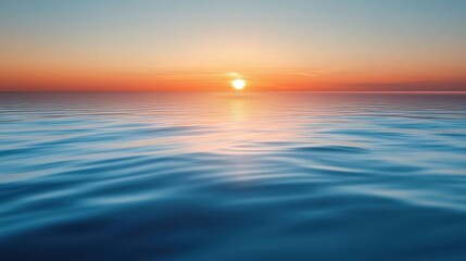 Obraz premium A serene sunset over calm ocean waters, showcasing vibrant hues of orange and blue reflecting beautifully on the surface.