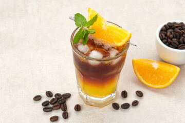 Iced americano black coffee and layer of orange juice  

