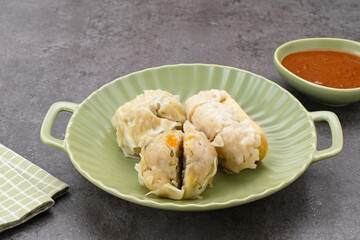 Siomay Bandung (Shumay) or steamed dumplings with boiled tofu. Indonesian traditional street food with peanut sauce.
