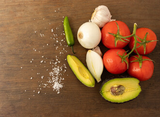 Guacamole with fresh ingredients on the table. Mexican food, concept.