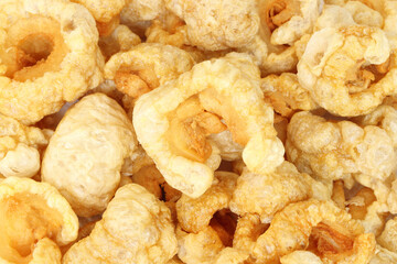 Closeup of pork snack or pork rinds, deep fried pork skin and blistered is traditional food in the north of Thailand.