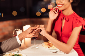 Loving Spouses Holding Hands Having Romantic Date Celebrating Anniversary Of Relationship Sitting In Restaurant. Cropped, Selective Focus
