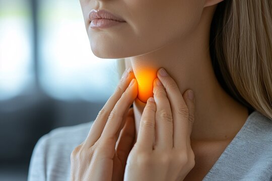 A woman self-examines her thyroid, which may be affected by conditions like goiter, hyperthyroidism, hypothyroidism, tumors, or cancer.