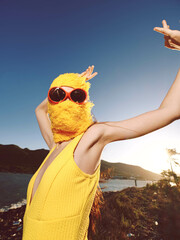 Beach, woman, yellow dress, sunglasses, ocean, mountains a woman in a vibrant yellow dress and...