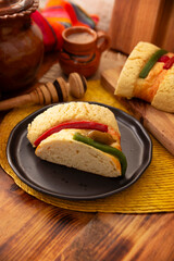 Traditional Kings day cake also called Rosca de Reyes, roscon, Epiphany Cake and and hot chocolate drink in a clay Jarrito. Mexican tradition on January 5th.