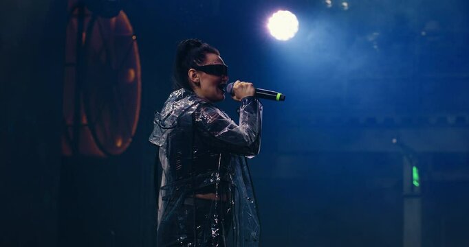 Beautiful Middle-Aged Woman Singing And Dancing On Stage, Contemporary Music Concert In Nightclub