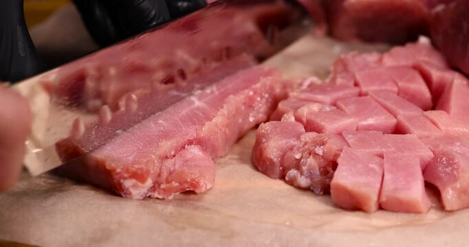 diced piece of pork fillet on a cutting board, sliced high-quality pork boneless meat