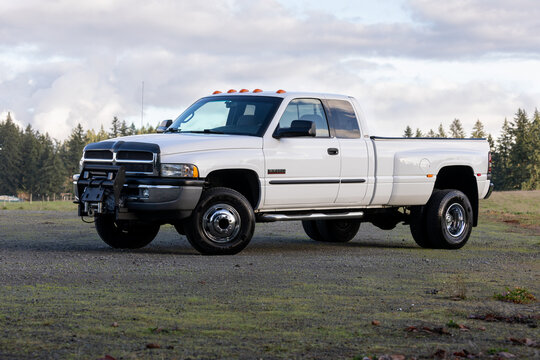 Portland, OR, USA - Dec 8, 2023 - 2001 White Dodge Ram 3500 dually Cummins 24 Valve Turbo Diesel 4x4  off-road American pickup truck exterior. High quality picture for download.
