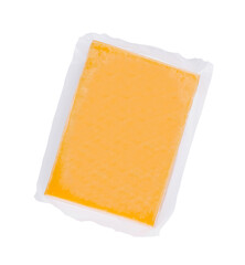 Vacuum packed block of cheddar cheese isolated on white background