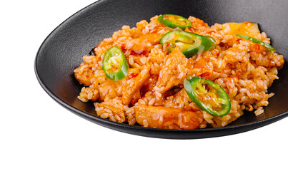 Spicy chicken and rice dish being served on black plate