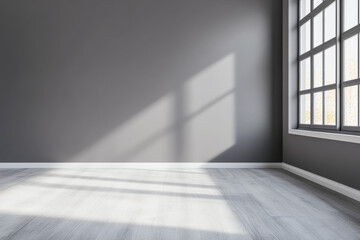 Sunlight casting shadows in a minimalistic gray room with large windows revealing a bright atmosphere