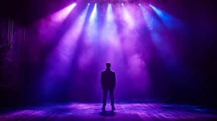 A Solitary Figure Standing on a Stage Bathed in Purple and Blue Light