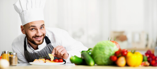 Chef Man Cooking Roasted Salmon Steak Plating Fish Dish Smiling At Camera Standing In Restaurant Kitchen. Selective Focus
