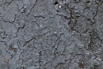 Background, texture thick layer of gray cracked paint on metal