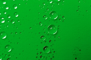Close up or macro photography of water droplets on dark green cover background. Water droplets and wallpaper concept