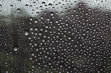 Rain water droplets on dark cover background. Water droplets and wallpaper design concept