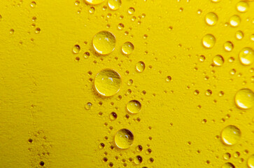 Close up or macro photography of water droplets on yellow cover background. Water droplets and wallpaper concept