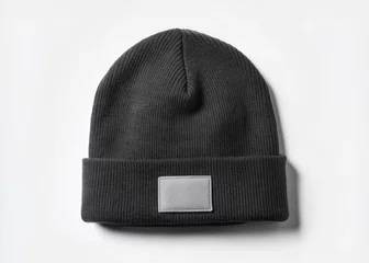 A stylish black beanie  mockup hat with a blank white label isolated on a plain background, perfect for adding your brand logo. © Four888