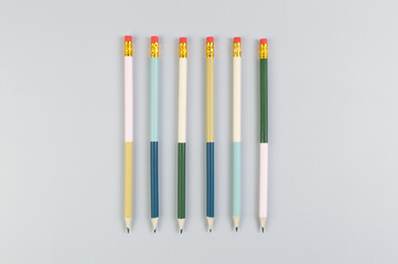 Fototapeta premium Top view of colorful pencils on grey background. School, office, art wallpaper. Flat lay, copy space.