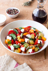 Salad with tomatoes, feta cheese, basil and balsamic vinegar. Healthy food. Vegetarian food.