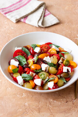Salad with tomatoes, feta cheese, basil and balsamic vinegar. Healthy food. Vegetarian food.