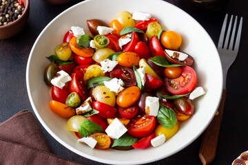 Salad with tomatoes, feta cheese, basil and balsamic vinegar. Healthy food. Vegetarian food.