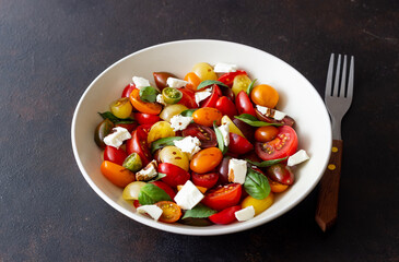 Salad with tomatoes, feta cheese, basil and balsamic vinegar. Healthy food. Vegetarian food.