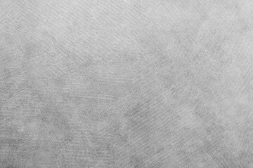 Abstract textured surface with subtle patterns in gray tones creating a soft background effect