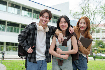 Bright Asian College Student Cheerful people use laptops and tablets to study with a group of classmates. Study outside in a fun way with good friends and social media. Concept of online education.