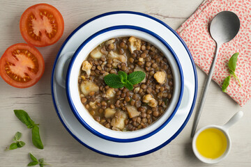 Lentil stew with potatoes, traditional Spanish tapa. Top view table with  decorations.