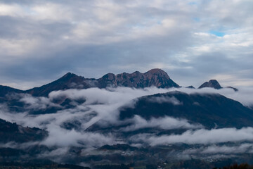 Obraz premium Scenic view of majestic mountain peak Mittagskogel (Kepa) in Karawanks seen from Rosental, Carinthia, Austria. Cloud covered alpine landscape. Peaceful scene in Austrian Alps in summer. Wanderlust