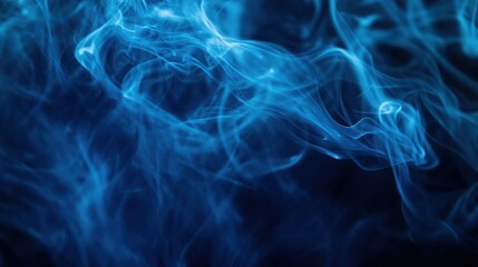 Obraz premium Abstract blue smoke or mist flowing and twisting on a dark background, adding a mysterious atmosphere Close-up photo with clean background