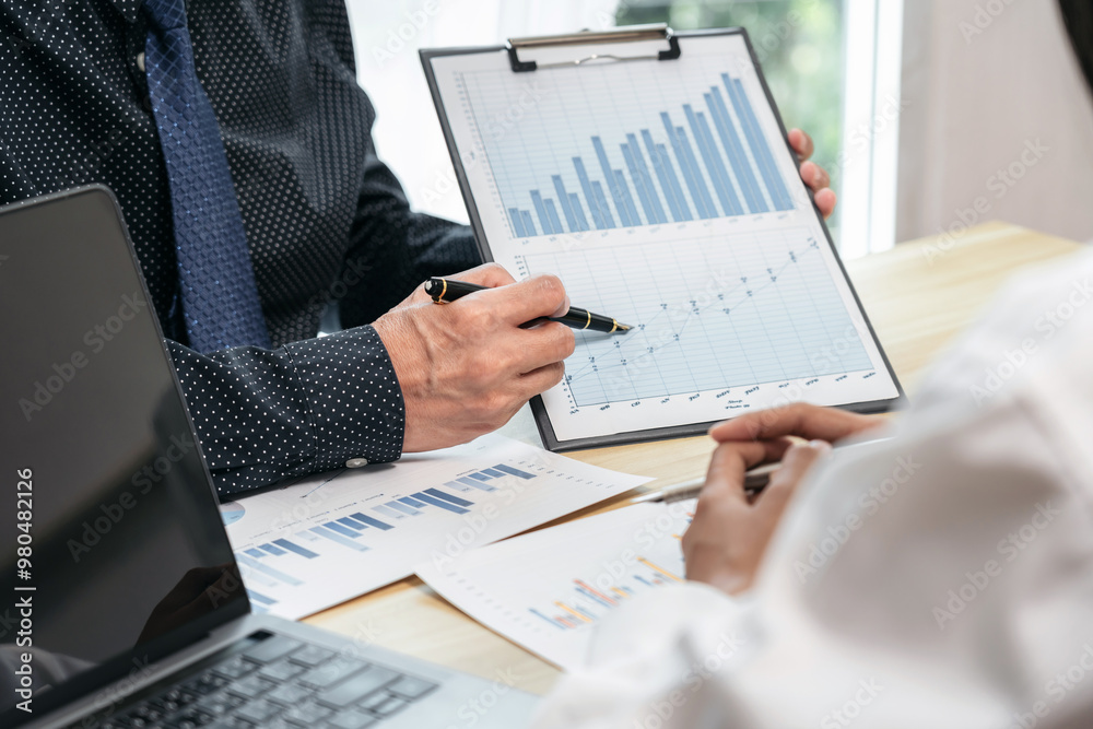 Aufkleber a man is holding a clipboard with graphs and a pen