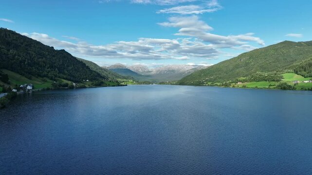 Oppheimsvatnet Lake in Voss with Brandset and Mjolfjell mountains in the background on a sunny summer day