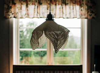 Swedish embroidered lamp hanging in a summer house